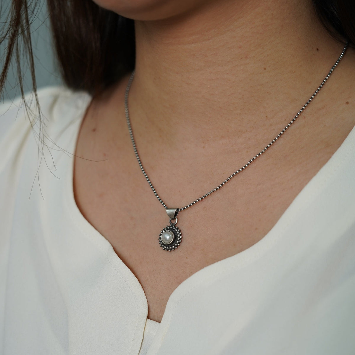 925 Silver Pearl necklace with a chain pendant worn by a model in a white top